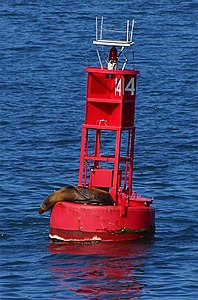 Red buoy in San Diego Harbor, with a light, number, and radar corner reflectors.