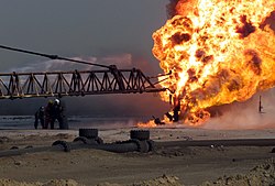 US Navy 030327-M-2306K-007 Firefighters fight an oil blaze in Gas-Oil Separation Plant Six as part of their ongoing support of Operation Iraqi Freedom