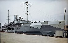 Color photograph of a ship docked at a yard