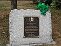 A photograph of the plaque with a stuffed Cthulhu