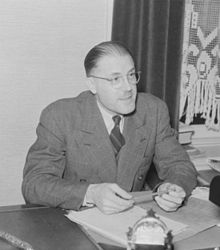 Claude Champagne sitting at his desk, 1941