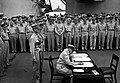 Gen. Douglas MacArthur signs as Supreme Allied Commander. Behind Gen. MacArthur are Lt. Gen. Jonathan Wainwright and Lt. Gen. A. E. Percival