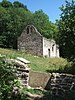 Ruins of stone church in green hills