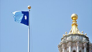 Minnesota flag flying on the eastern flagpole