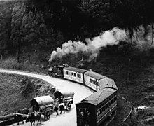 Steam passenger train rounding a curve