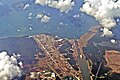 Aerial view of Gatun Locks, Panama Canal. On top, several vessels waiting at Gatun Lake to cross the locks. At the bottom is exit canal to the Atlantic Ocean (Caribbean Sea)