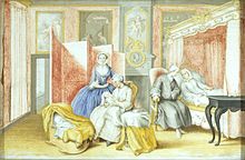 A bedroom with a young woman in white laying on the pink, canopy bed. A man in a gray coat is sitting next to her, leaning towards her. A woman in white is seated in the middle, nursing a swaddled baby, with a young woman in blue looking on. Next to them is a crib.