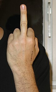 The front of a man's hand with his middle finger raised