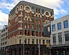 A seven-storey commercial building made mainly of red and white masonry