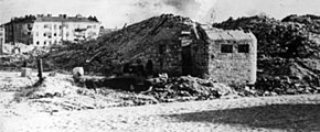 Ruins of the concentration camp, with remnants of what was a bunker seen in the foreground