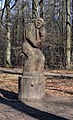 Wooden Neanderthaler sculpture by Ad Wouters in Heverleebos