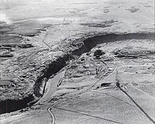 Aerial view of a river cutting a canyon through a rocky plateau.