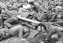 Many soldiers sleeping on the ground