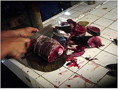 A scombrid, being chopped into fillets at the Danao City Public Market in Cebu