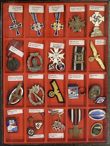 File:Third Reich Nazi Germany Military Civil decorations Insignia Badges Pins Mother cross etc Norwegian descriptions Lofoten Krigsminnemuseum WW2 Museum Norway 2019-05-08 DSC09820 Cropped Adjusted perspective.jpg