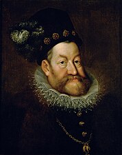 Portrait d'un homme barbu, habillé richement d'un costume sombre, portant une fraise en dentelle et coiffé d'une sorte de toque sombre elle aussi.