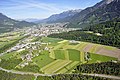 Luftbildaufnahme der Stadt Bludenz Richtung Nordwesten; im Vordergrund der Ortsteil Brunnenfeld und die Arlberg Schnellstraße S16, im Mittelgrund ist die Arlbergbahn am Waldrand verlaufend erkennbar