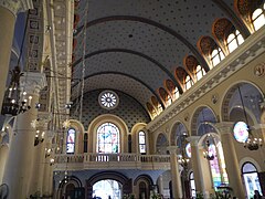 Church interior facing the choir loft. Note the arcade, clerestories, and rose window.