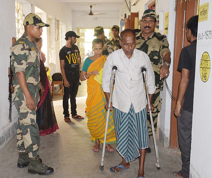 File:Security personnel assisting a Divyang voter at a polling booth during the 5th Phase of General Elections-2024 at Serampore, in West Bengal on May 20, 2024.jpg