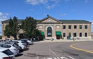 A large brick train station at the end of an urban street