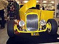 Deuce roadster with a bobbed frame, dropped axle, disc brakes, and coilovers. Note the contrast with the stock frame rails.