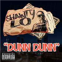 The cover features a paper bag carrying the artist's name and face on it filled with cash inside, with more under the bag. Below is the song title colored in orange. At the bottom left corner is the Parental Advisory label.