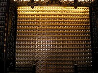 Wall with some of the smaller Buddha statues inside the temple