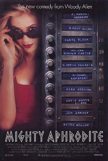 A blonde woman in a red dress, lowering her sunglasses. A column of names in the style of an apartment door buzzer.