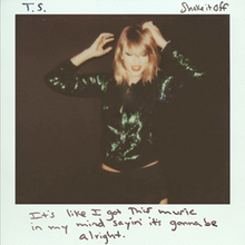 Cover artwork of "Shake It Off", a polaroid photo of Swift dancing