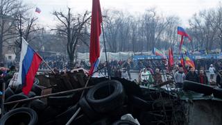 Pro-russische Demonstranten stehen während einer Kundgebung in Lugansk vor den Barrikaden um das von Milizen besetzte Regierungsgebäude.