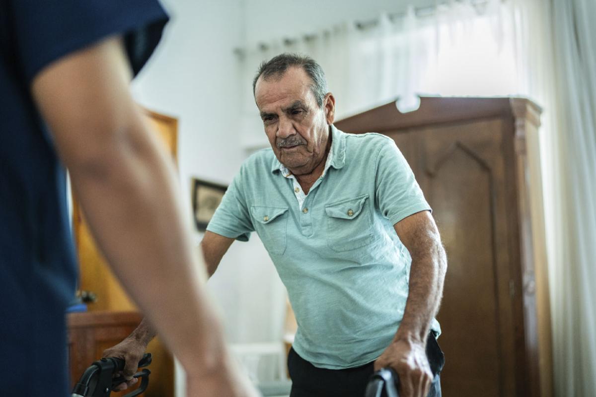 Person uses a walker with in-home physical therapy