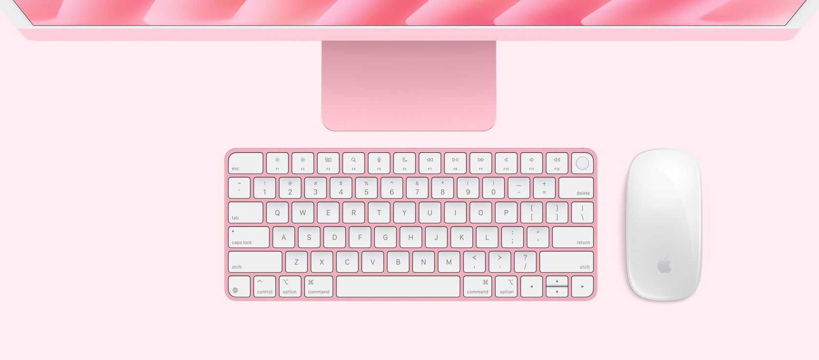 Overhead view of a pink iMac with colour-matching mouse and keyboard