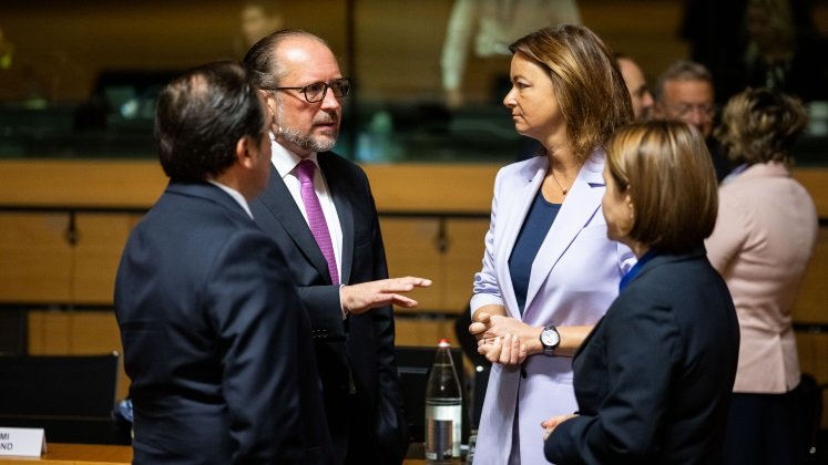 Außenminister Schallenberg stehend im Gespräch mit der slowenischen Außenministerin Tanja Fajon und zwei weiteren Kolleginnen, bzw. Kollegen