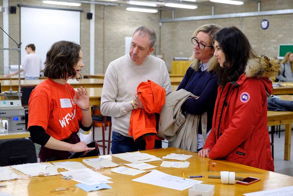 A student ambassador speaking to a family at an open day