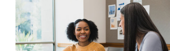 Two students smiling