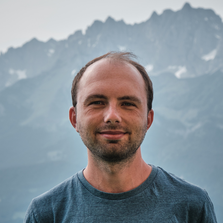 Me in a blue t-shirt in front of the beautiful alpes in austria