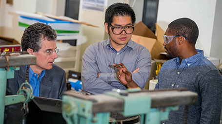 Students talking with a professor in the Ford Design Center.