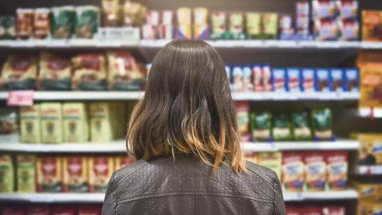 A woman shopping for groceries at a supermarket.