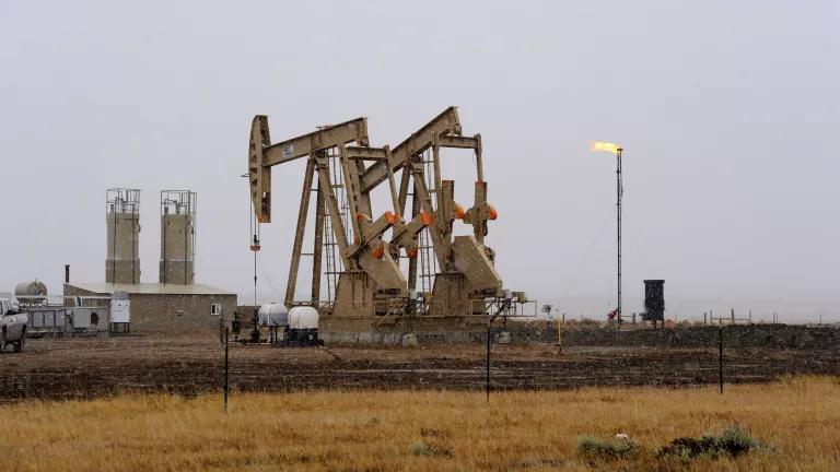 Oil pumpjacks and a burning gas flare in Walden, Colorado, during a snowstorm on October 17, 2011.