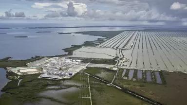 An aerial view of a nuclear power plant along a body of water