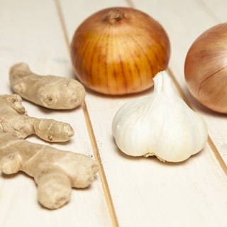 In Ingwer, Zwiebeln und Knoblauch stecken Inhaltsstoffe, die uns im Kampf gegen eine Erkältung helfen