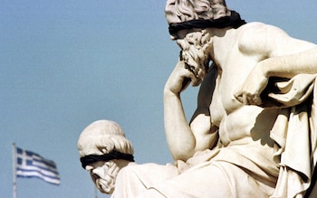 Statues of the philosophers Plato and Socrates in Athens