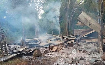 Smoke rises from debris and corrugated roofing of a school structure that was burned to the ground in Taung Myint village in the Magway region of Myanmar 