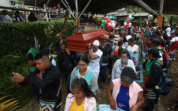 Mourners carry the coffin of 14-year-old Colombian  environmental activist Breiner David Cucuname, who was shot dead