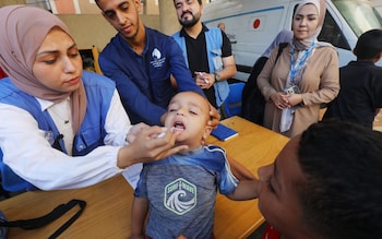 Palestinian medics administer polio vaccines to children at UNRWA clinic in Deir al-Balah camp in Gaza