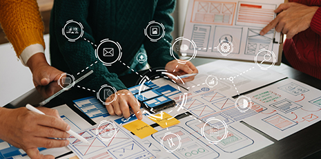 Web development team reviews wireframe for UI/UX design.