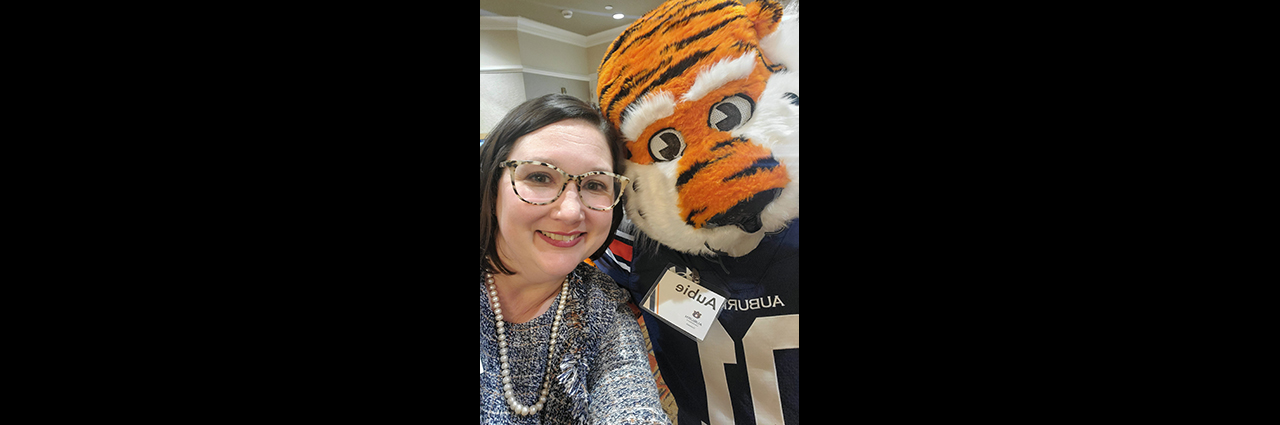 Female event attendee with Aubie.