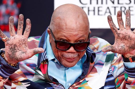 Quincy Jones pokazuje swoje donie po umieszczeniu ich w cemencie podczas ceremonii na dziedzicu chiskiego teatru TCL w Los Angeles,, 27 listopada 2018 r.