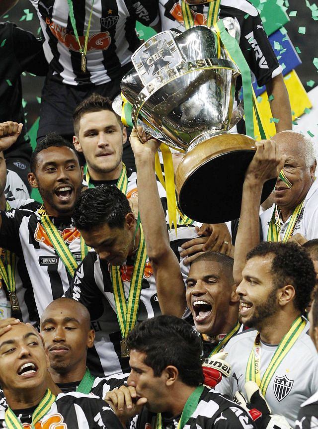 Silva of Atletico Mineiro celebrates with the Copa do Brasil trophy with teammates after winning the final soccer match against Cruzeiro at Mineirao stadium in Belo Horizonte