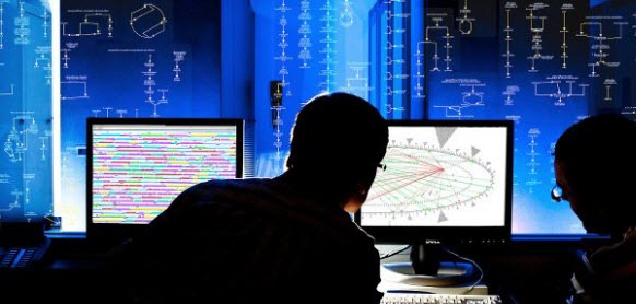 Two men looking at two screens, one
		  showing a genome browser display, the other a
		  regulatory overview display. Behind the
		  screens is a blue background with a portion
		  of a cellular overview diagram visible.